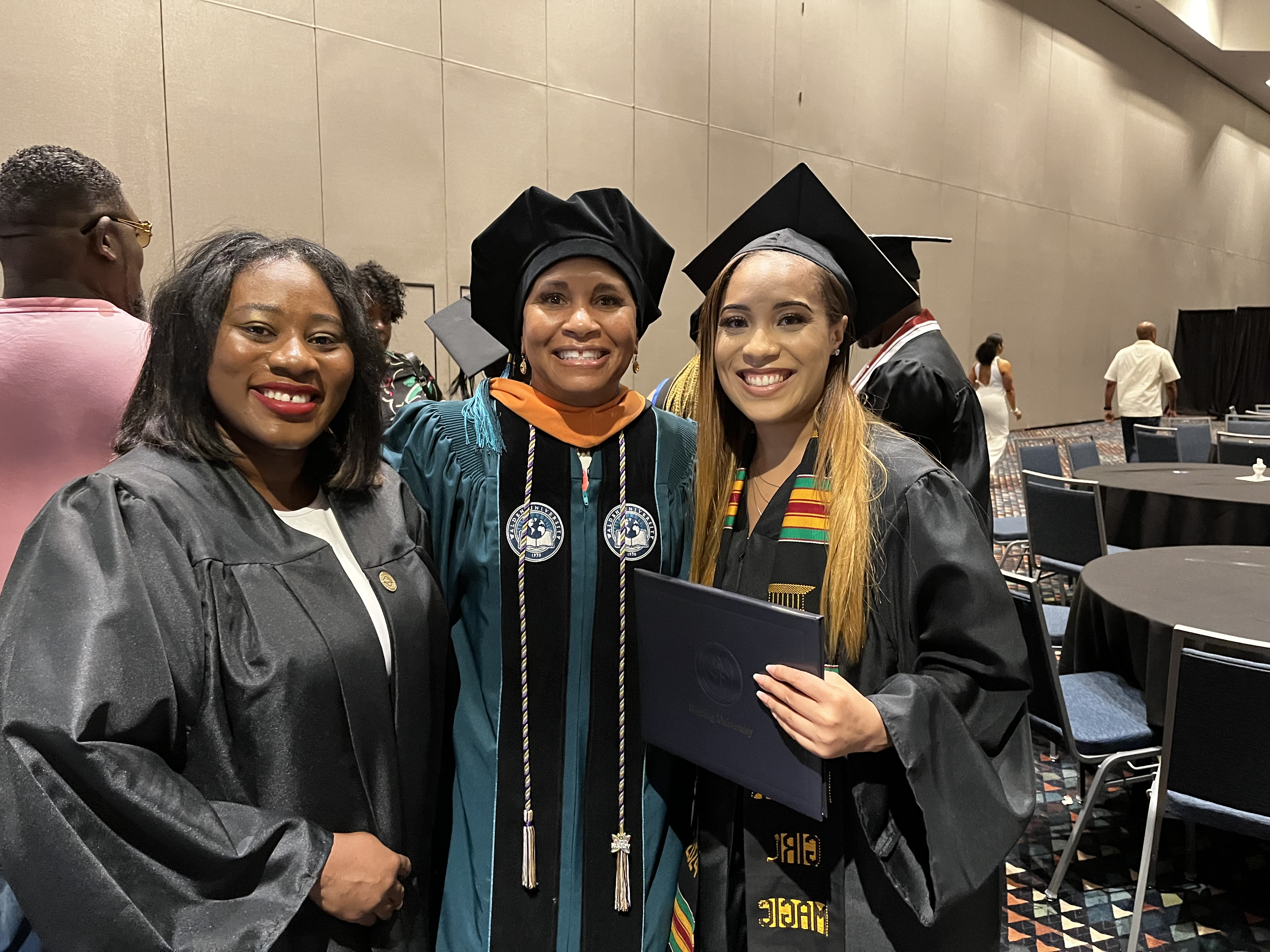 Juanita Rainey at graduation with another Herzing student